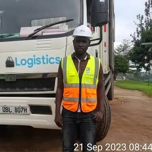 Klan Logistics driver beside a delivery truck