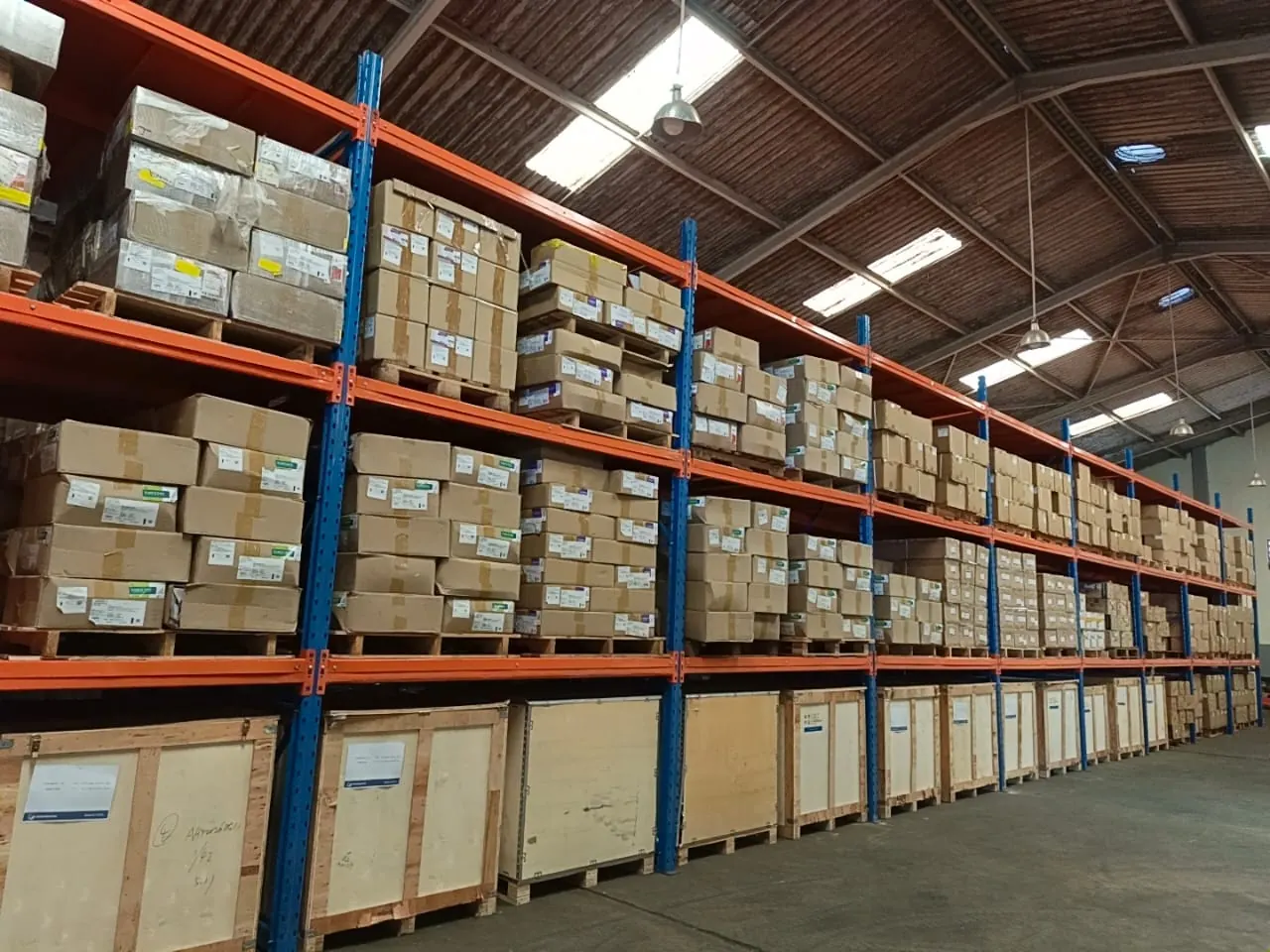 Pallet racking stocked with wrapped inventory inside Klan Logistics' Kampala warehouse